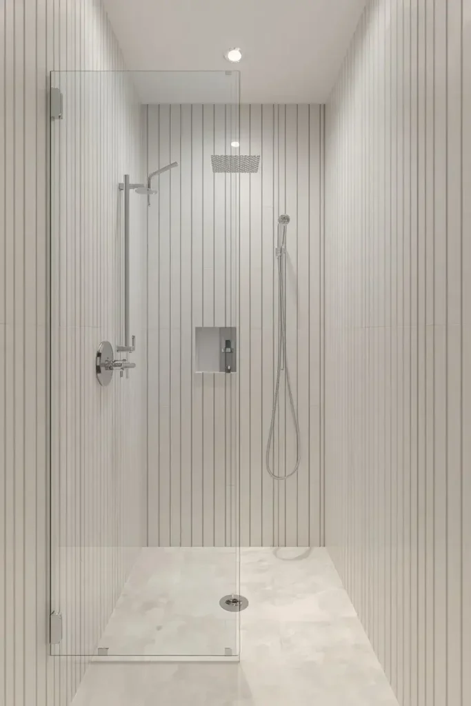 Small shower with vertical white tiles that make the ceiling appear taller
