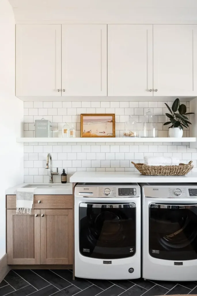 Laundry room with a white subway tile backsplash, wood cabinets, and white appliances.