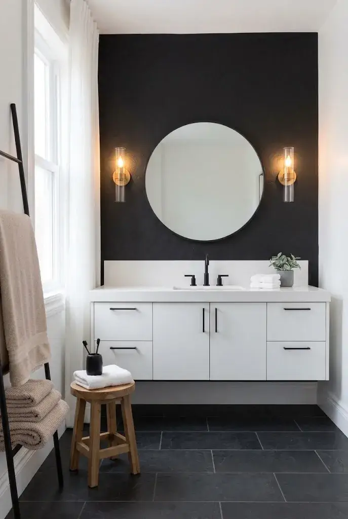 Modern bathroom with a matte black accent wall behind a white floating vanity.