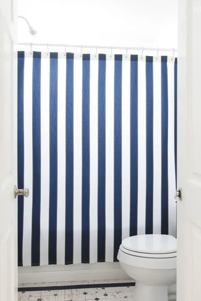 Navy and white striped bathroom curtain idea for a classic look