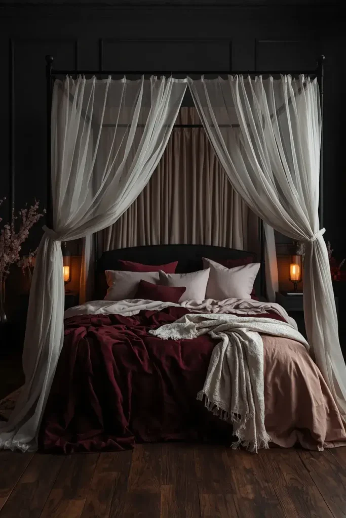 Romantic canopy bed with sheer cream fabric and burgundy feminine bedding.