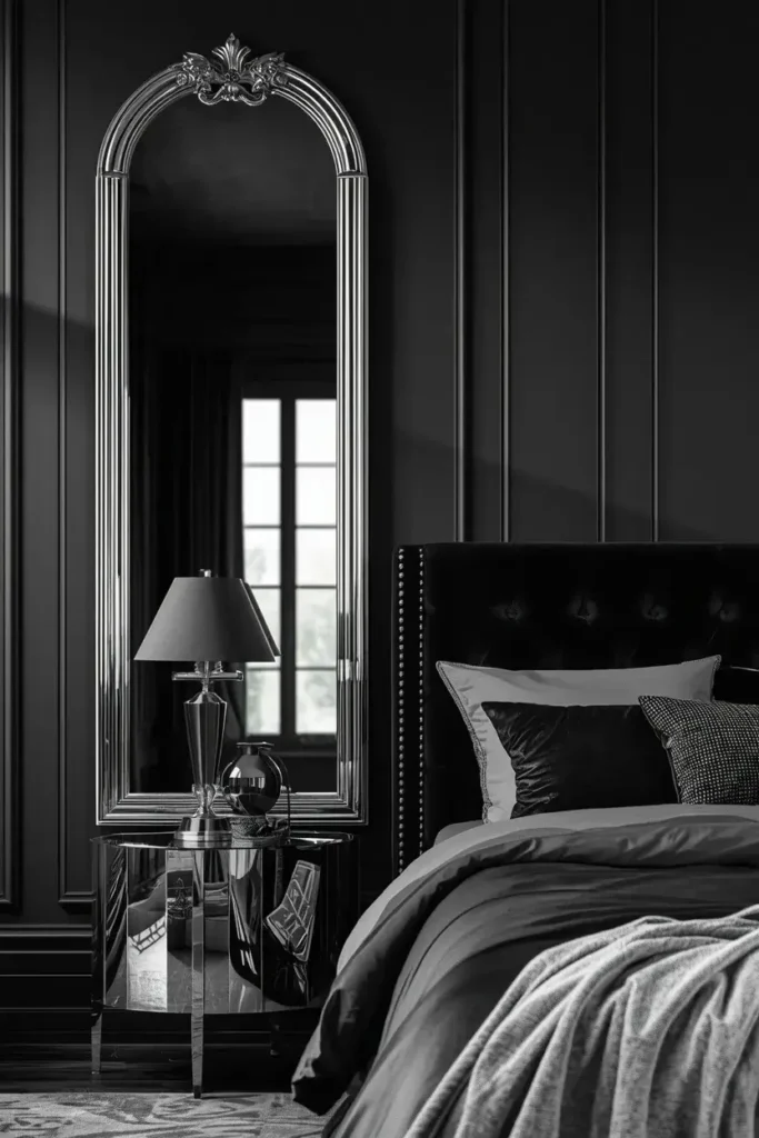 Large silver statement mirror brightening a sophisticated black bedroom