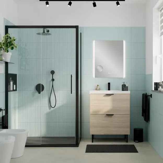Modern light blue bathroom with matte black faucets, shower fixtures, black accents, white vanity, and natural wood details.
