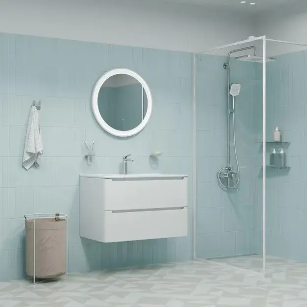 Small light blue bathroom with a floating vanity, large mirror, white tiles, glass shower, and compact storage.